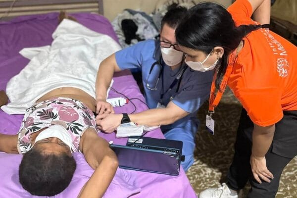 IMR provider using a butterfly ultrasound on a patient