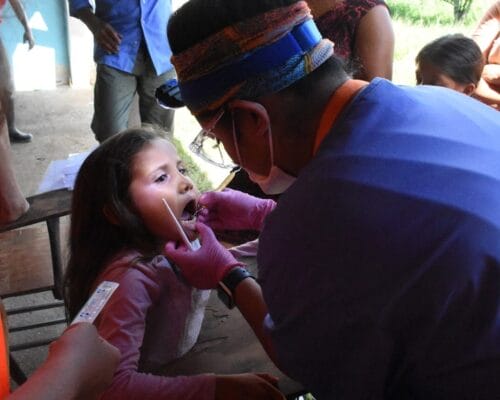 Girl being examined by an IMR dental volunteer: Dental Volunteer Opportunities with IMR